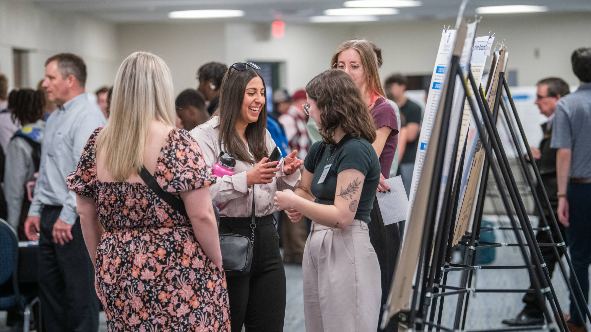 Students engage with project posters at Student Scholars Day